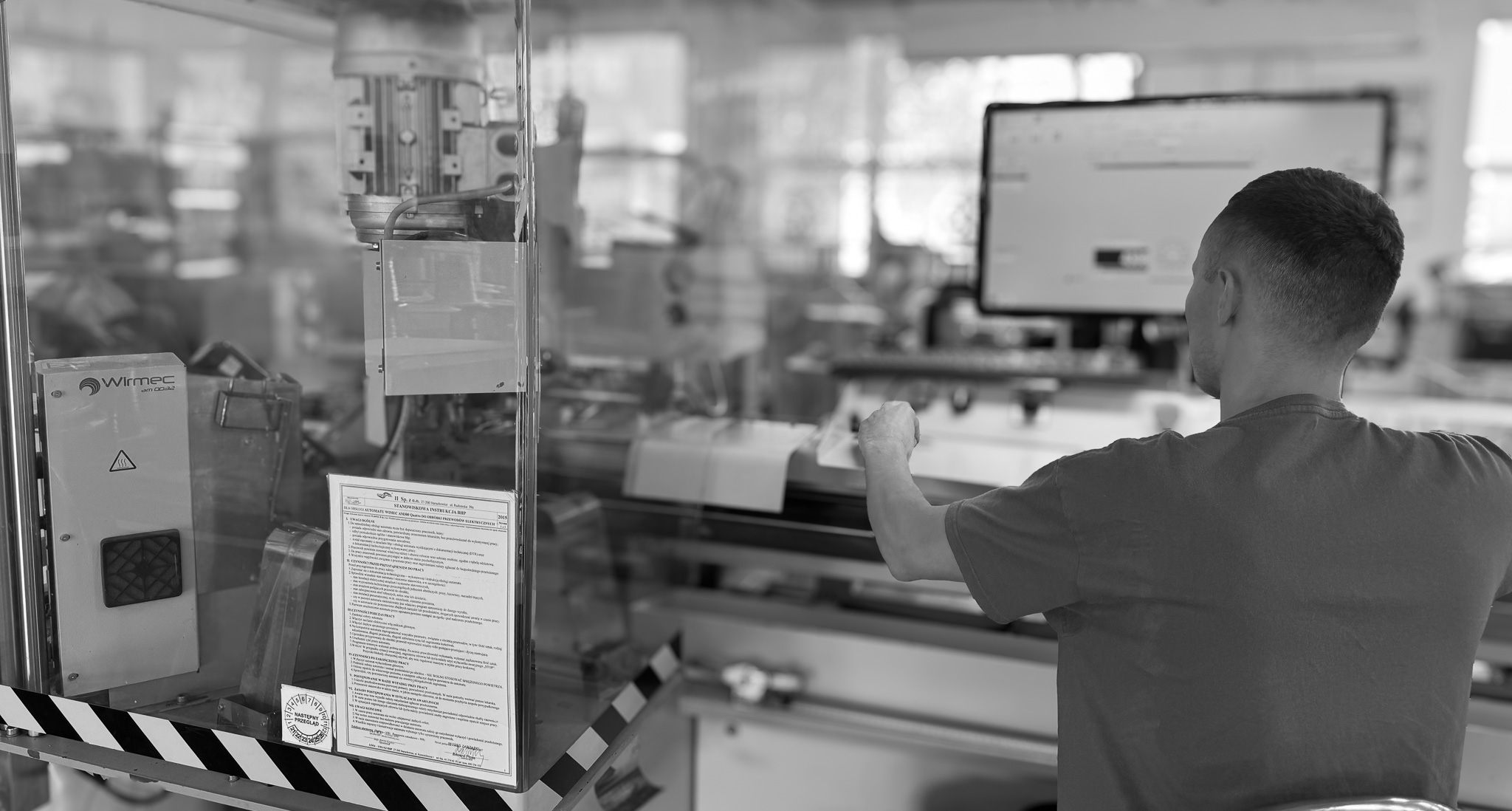 Pracownik Starpol obsługujący maszynę do produkcji wiązek elektrycznych
